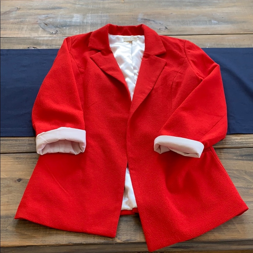 Red blazer by tea and cup